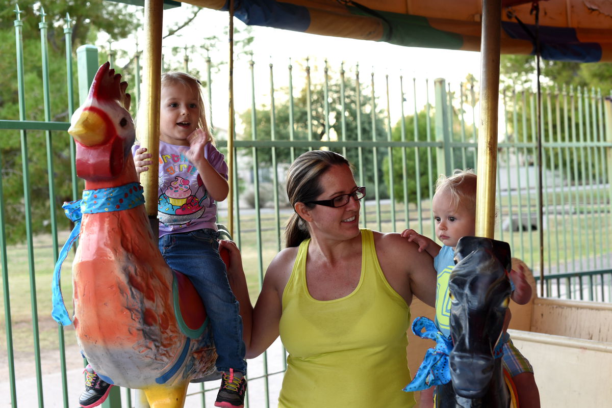 Priya, Remy, and Jen on merry go round