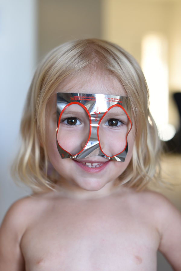 Priya wearing a AAA sticker for a mask