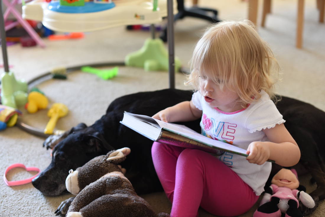Priya reading a story to Simone