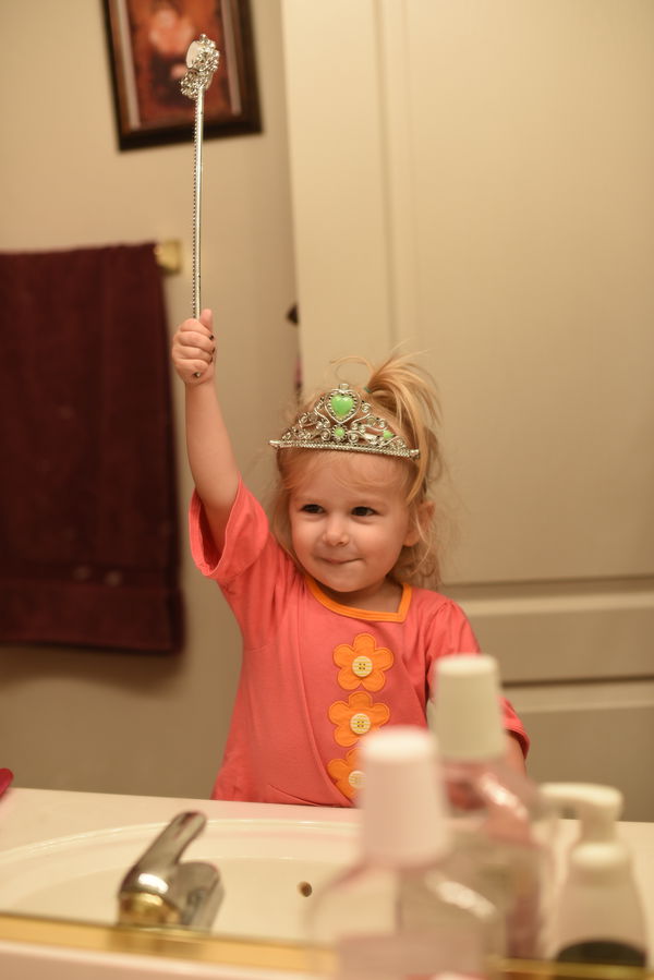 Priya in the mirror wearing her crown