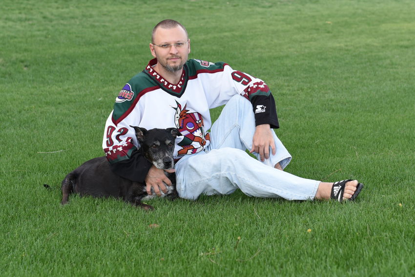 Simone and Clint sitting on grass; Simone is 14