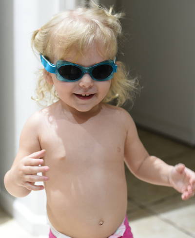 Priya wearing goggles by dishwasher