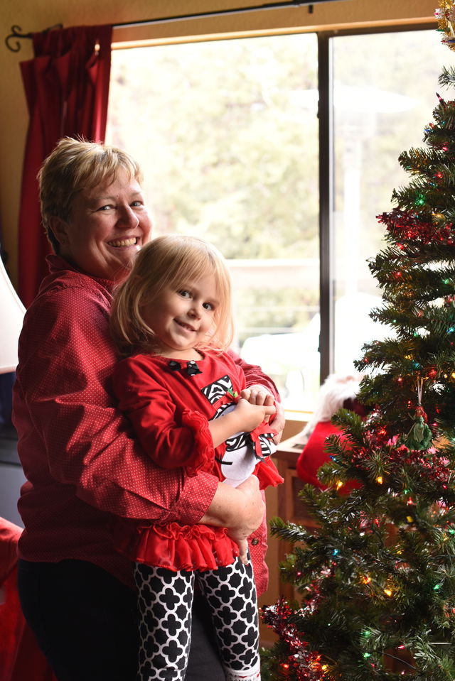 Priya and Grandma hanging Ariel on the tree
