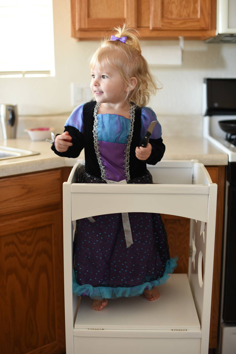 Priya in her kitchen stand