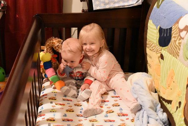 Remy and Priya hugging in crib