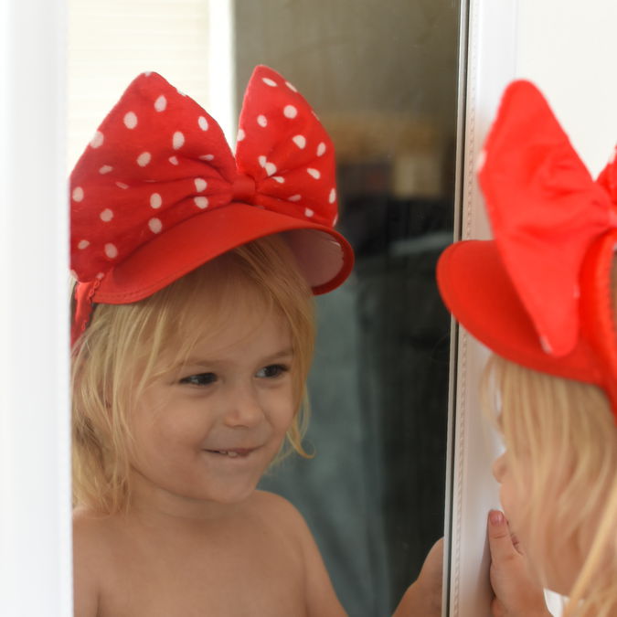 Priya wearing her Mini Mouse hat