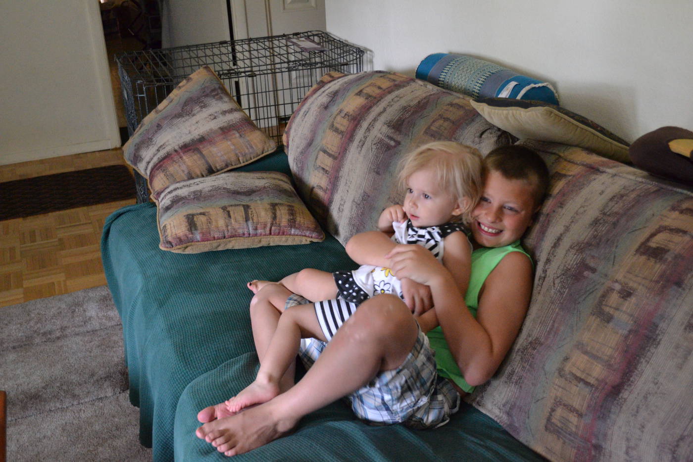 Ben holding Priya on couch